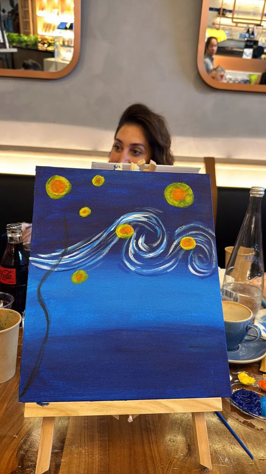 Close-up of a guest's Starry Night painting on a tabletop easel