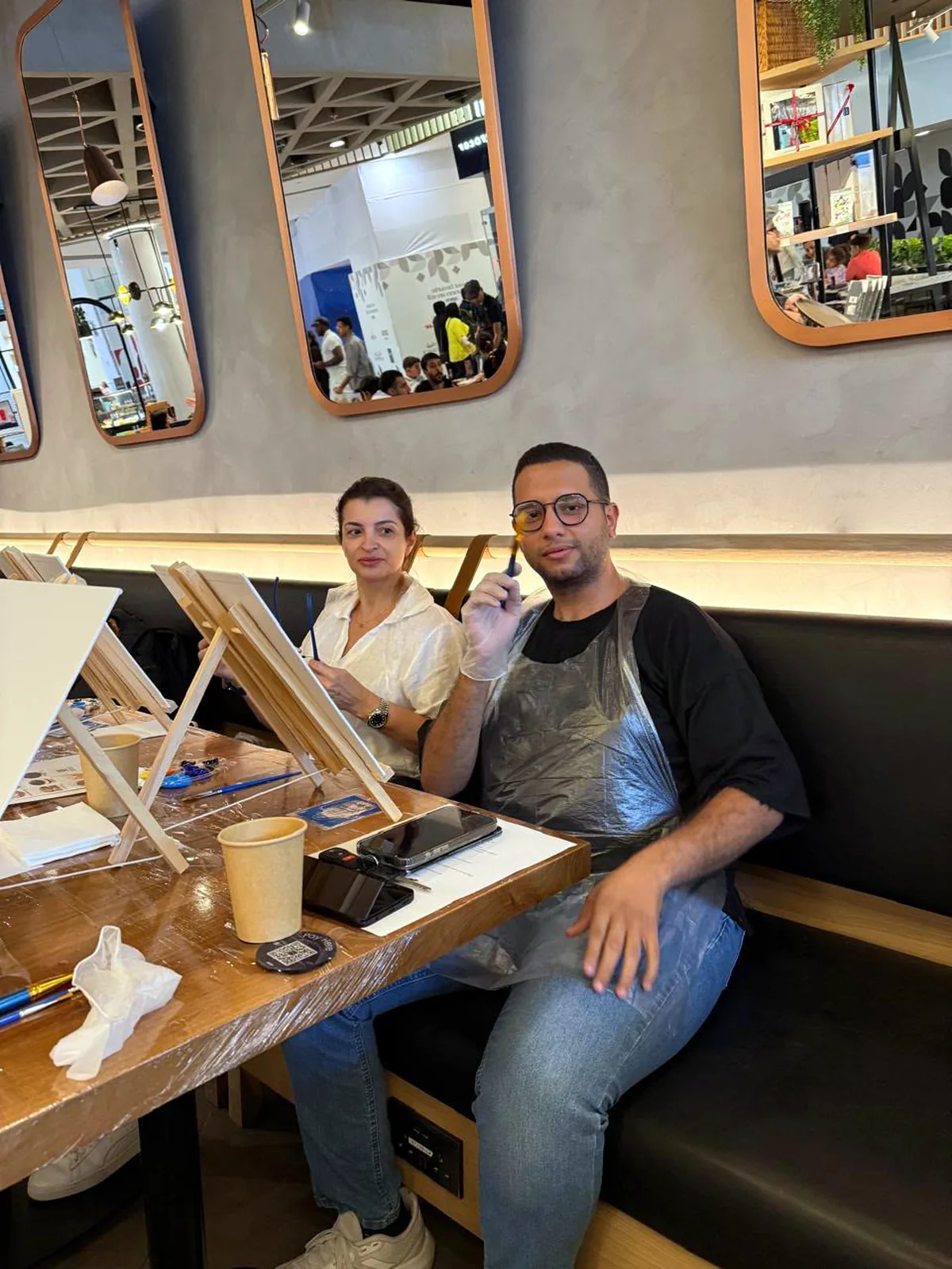 Guests enjoying a CANVAS Starry Night painting session in a Dubai café