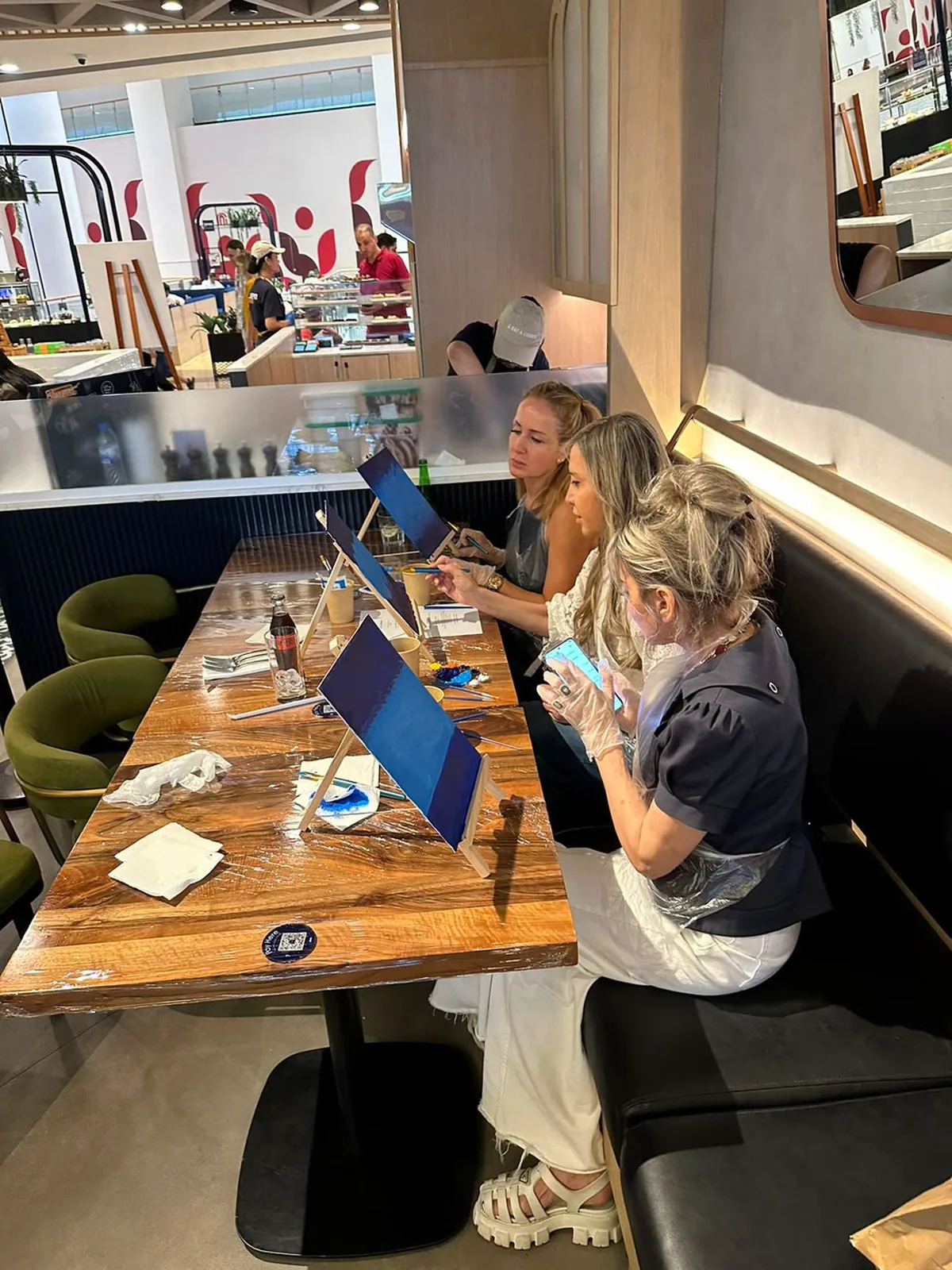 Guests enjoying a CANVAS Starry Night painting session in a Dubai café