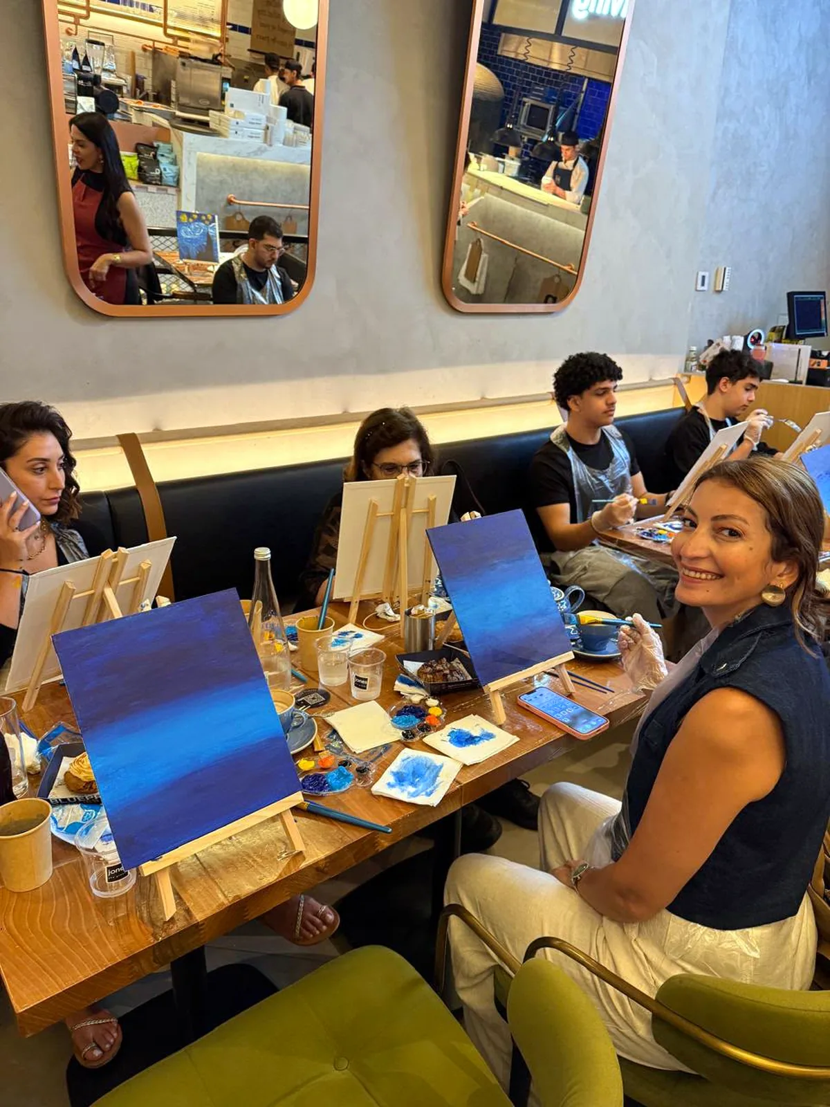 Guests painting Starry Night on tabletop easels at a CANVAS session
