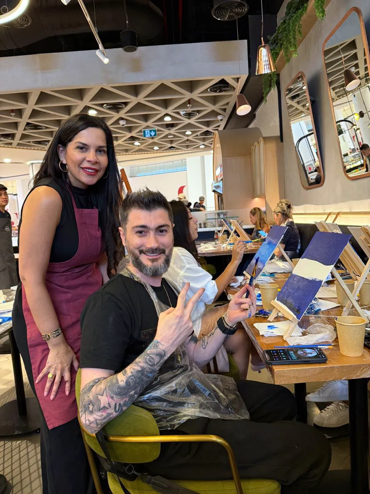 Guests enjoying a CANVAS Starry Night painting session in a Dubai café