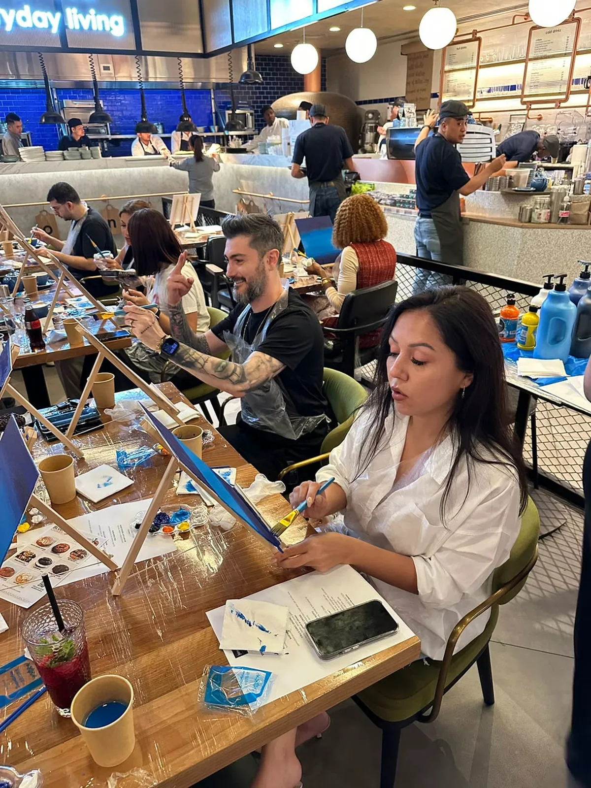 Guests enjoying a CANVAS Starry Night painting session in a Dubai café