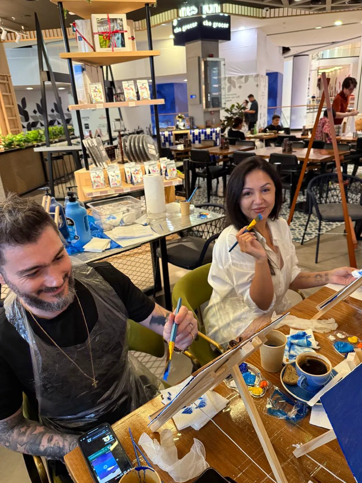 Guests painting Starry Night on tabletop easels at a CANVAS session