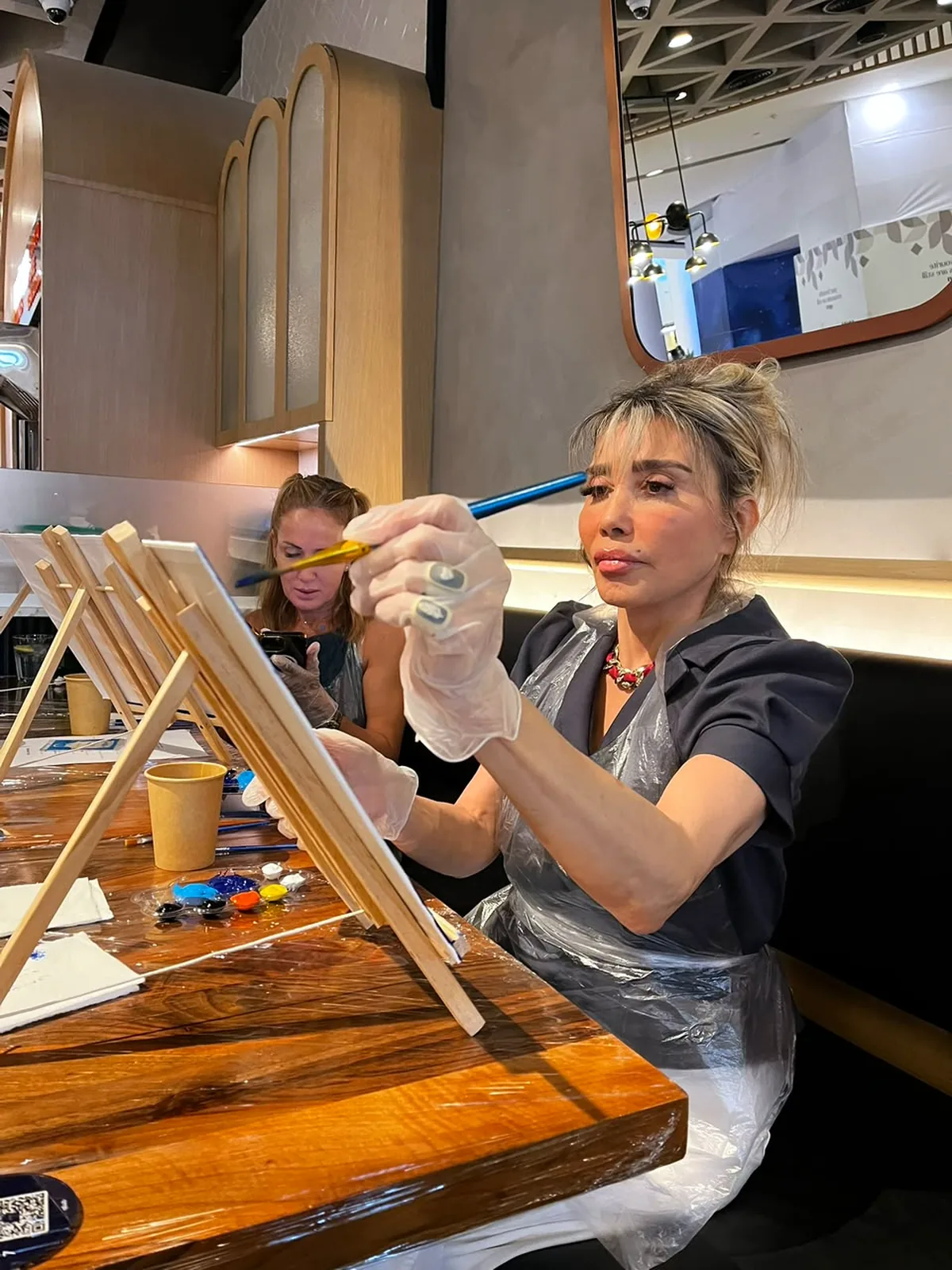 Guests enjoying a CANVAS Starry Night painting session in a Dubai café