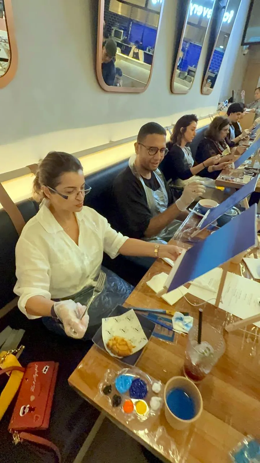 Guests enjoying a CANVAS Starry Night painting session in a Dubai café